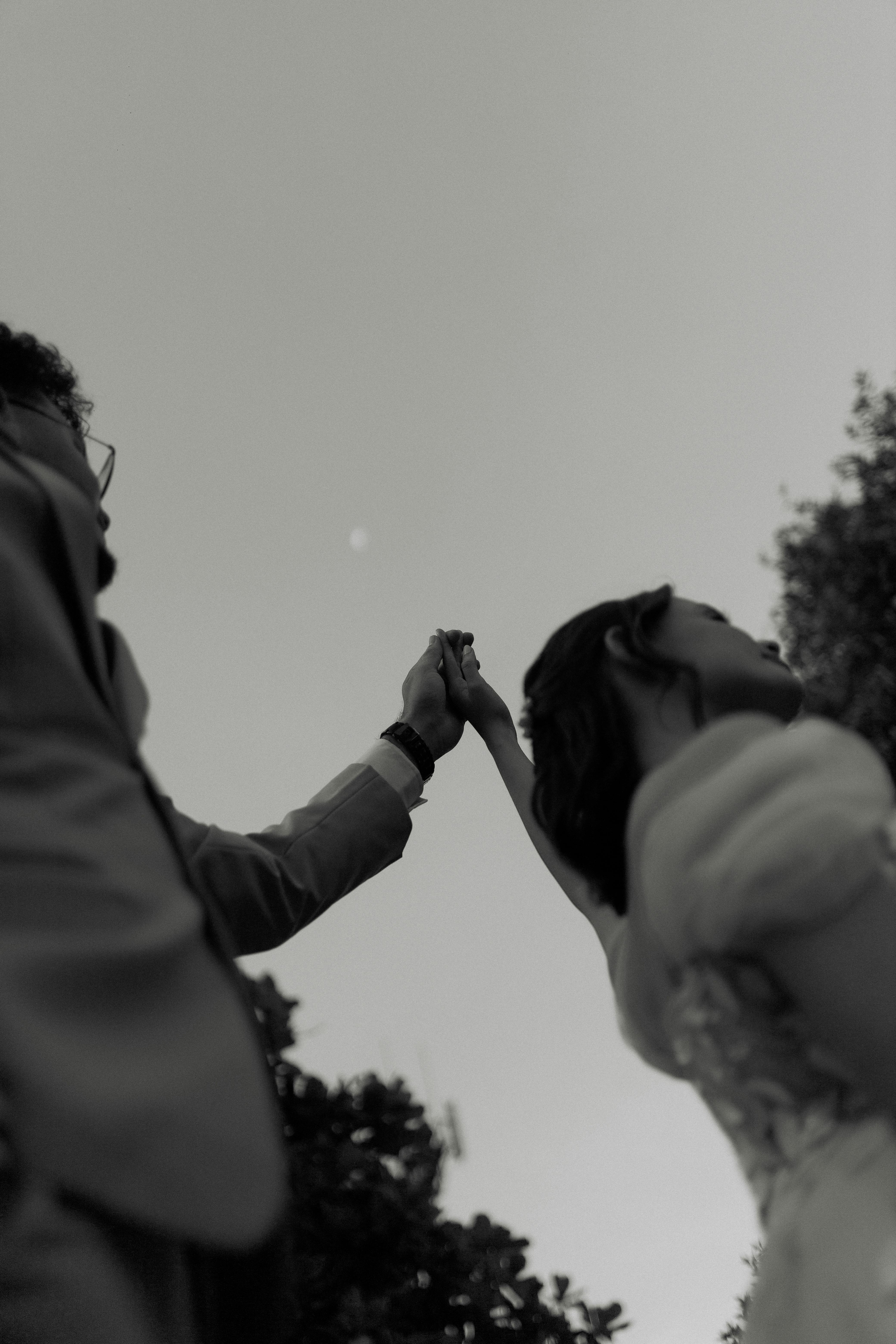 Couple holding hands under moonlight